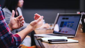 A photo of a person's hands while they work in front of a laptop