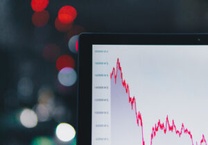 A photo of a laptop screen displaying a stock market graph